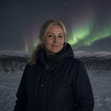Aino Korhonen, Lapland tour specialist, photographed under the northern lights in Finnish Lapland